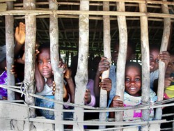 School-children peeping through the holes of their school building in Lokanja Lina Nkoy village, Orientale province  Photo: Hugo R�mi/IRIN