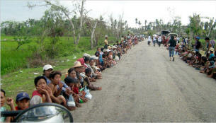 On a road near Pyapon, in an area of Myanmar ravaged by a cyclone, people waited on Sunday for aid from Burmese civilians. Photo: NYT
