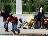 Protesters ran for cover as shots rang out near the palace. Photo: AP