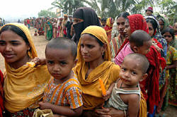 People have to wait for hours to buy 5kg of rice at open market sale (OMS) centers in Bangladesh. Photo: Shamsuddin Ahmed/IRIN