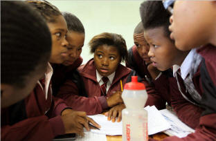 In the absence of a teacher, students discussed their work at a high school in Khayelitsha, on the outskirts of Cape Town.  Photo: Joao Silva/New York Times