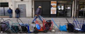 Patrons line up grocery carts to wait for the opening of a food pantry in Harlem. After a U-turn in the politics of poverty, food stamps, a program once scorned as “welfare,” enjoys broad new support. Following deep cuts in the 1990s, Congress reversed course to expand eligibility, cut red tape and burnish the program’s image, with a special effort to enroll the working poor. These changes, combined with soaring unemployment, have pushed enrollment to record highs, with one in eight Americans now getting aid. Photo: Stephen Crowley/New York Times