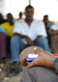 Mozambique: A HALO Trust instructor teaches new recruits about landmines. The instructor is holding a small mine, known as a "toepopper", designed to blow a foot off.   Photo: © Guy Oliver/IRIN