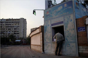 A Cairo vendor sells Safi bottled water. The brand is owned by Egypt's military, which operates a wide variety of businesses. Photo: Ed Ou/New York Times