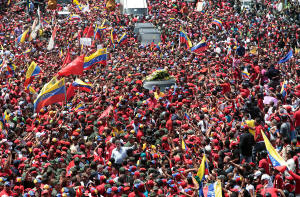 Photo of thousands of supporters in Caracas accompanying the funeral cortege of President Hugo Chávez on its way to the Military Academy. Photo: Miguel Angel Angulo/Agence France-Presse — Getty Images