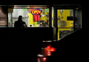 Photo of man drinking coffee at a diiner in the early morning. The ranks of the so-called working poor have grown even as the nation is showing signs of shaking off the worst effects of the recession. Photo: Michael S Williamson/Washington Post