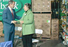 President George Bush and Capital Area Food Bank President Lynn Brantley at the CAFB, December 19, 2002. President Bush spoke in support of volunteerism. 