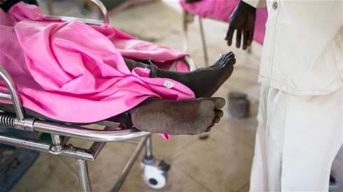 Injured man on a hospital gurney in South Sudan. Photo: Mackenzie Knowles-Coursin/IRIN