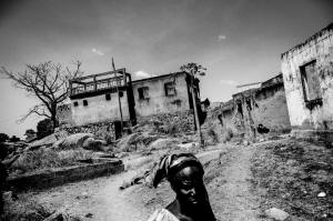 A woman walks in the burned down and completely destroyed Christian neighborhood of Jos, Nigeria. (Andy Spyra/Laif/Redux)